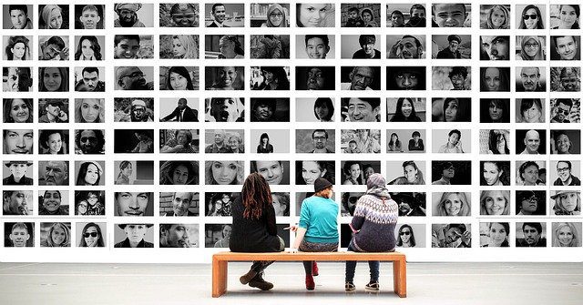 people looking at photos of other people