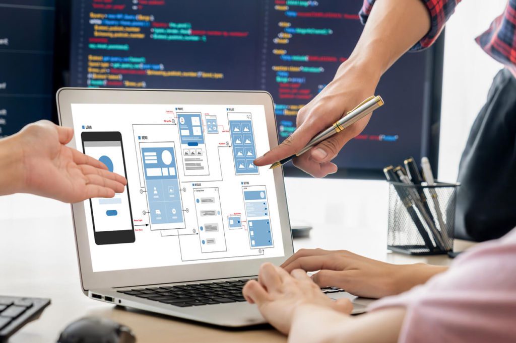 team collaborating with developers on mockups