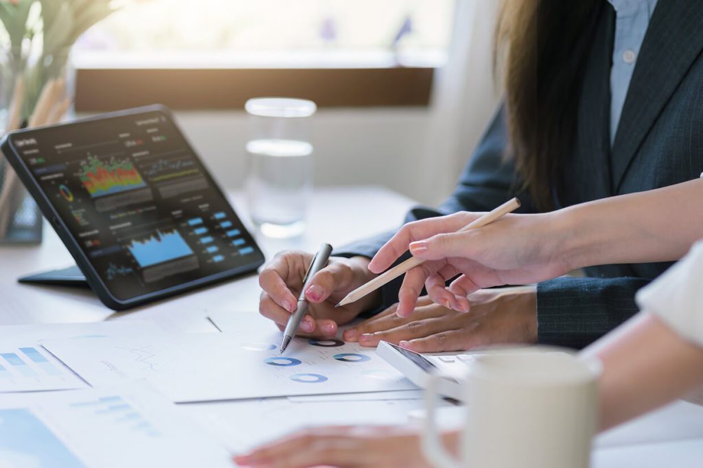 Women discussing results with tablet and cup on table