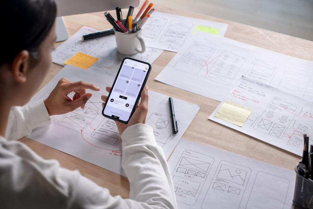 woman viewing ADA-compliant wireframes on mobile